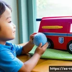 로보카폴리 장난감 사용법 - The younger child, wearing a colorful t-shirt and comfortable shorts, is holding a toy Poli police c...